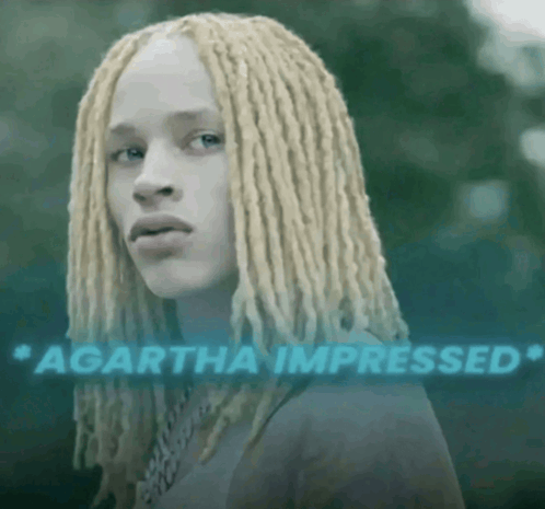 a woman with blonde dreadlocks and the words " agartha impressed " behind her