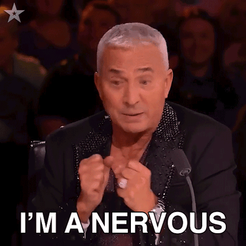 a man sitting in front of a microphone with the words i 'm a nervous on his face