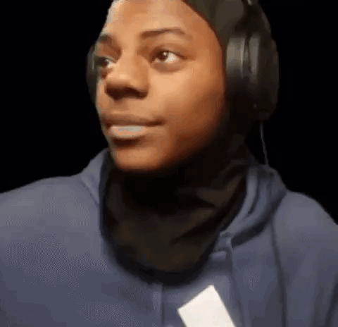 IShowSpeed in headphones gives a skeptical sideways look.