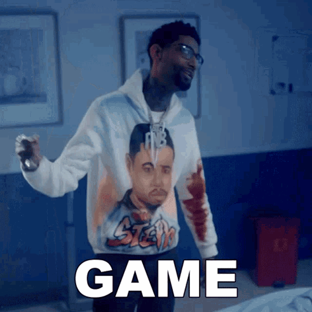 a man wearing a hoodie with a picture of a man and the word game
