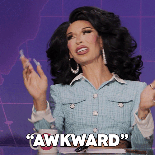 A drag performer shrugs under large text reading “AWKWARD.”