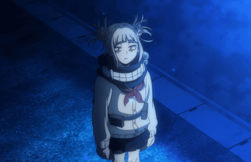 a girl with pigtails and a scarf around her neck is standing in the dark