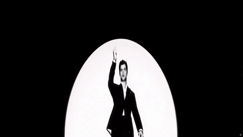 a black and white photo of a man in a suit and tie