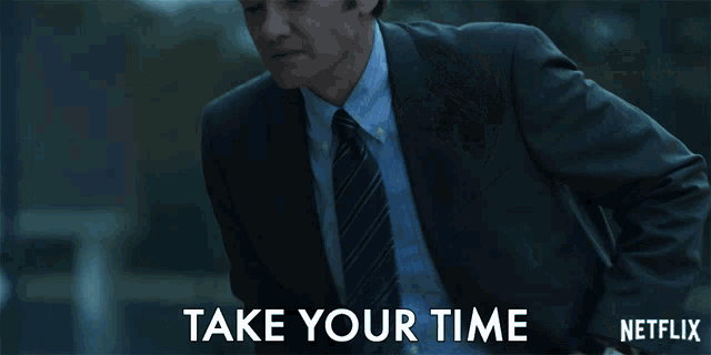 a man in a suit says " take your time " in a netflix ad