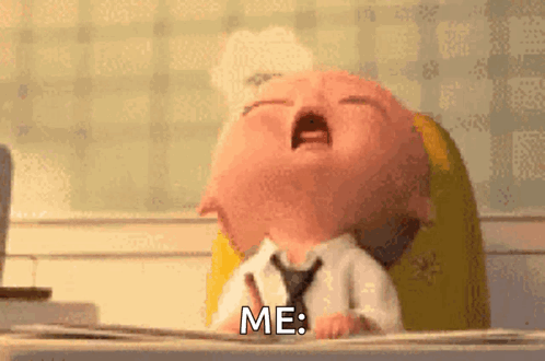 A baby at a desk yawns with the caption “ME.”