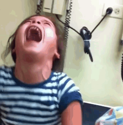 A child throws their head back and screams.