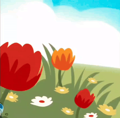 Red tulips bloom in a sunny green field beneath a blue sky.