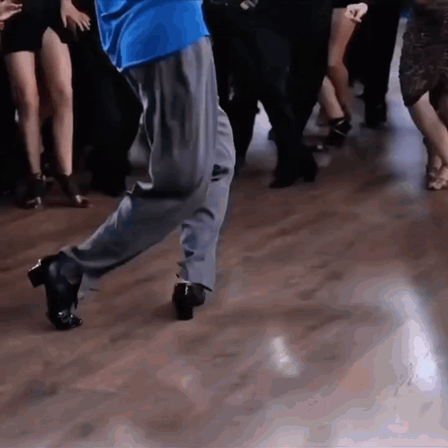 Close-up of feet performing fast salsa-style dance steps.