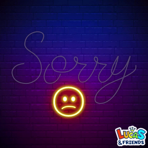 Neon cursive “Sorry” glows on a brick wall above a sad face.