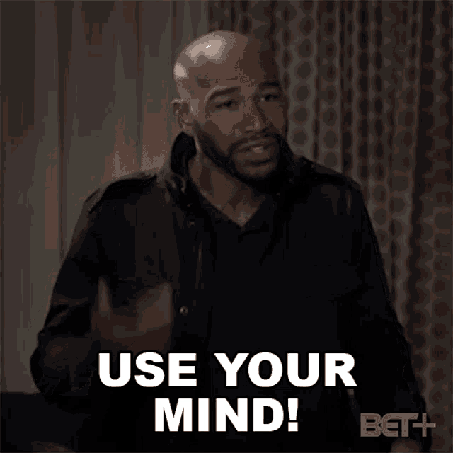 a man is pointing his finger at his head and says use your mind