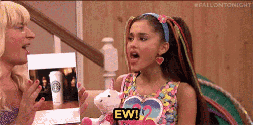Ariana Grande reacts open-mouthed beside another woman with a small “EW!” caption.