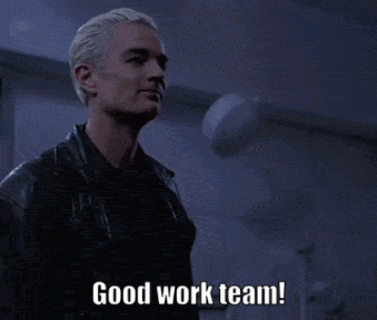 a man in a leather jacket says good work team in a dark room