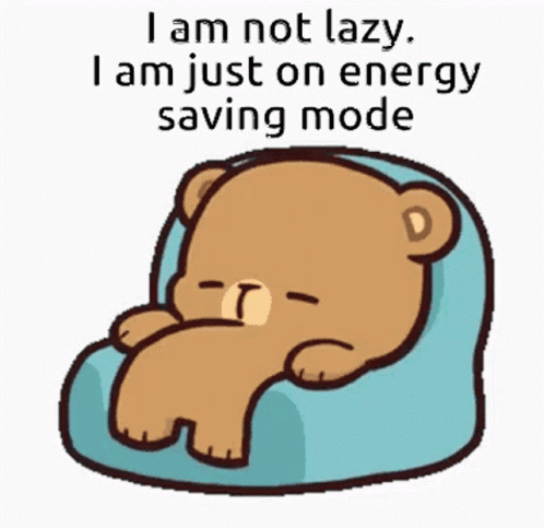 A bear rests in a chair beside the caption “I am not lazy, I am just on energy saver mode.”