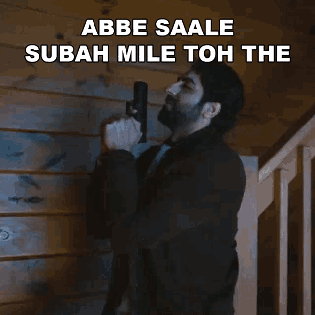 a man holding a gun with the words abbe saale sabah mile toh the below him
