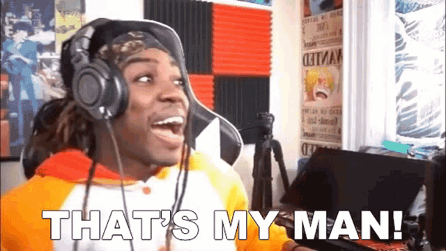 a man wearing headphones and a hat says that 's my man !
