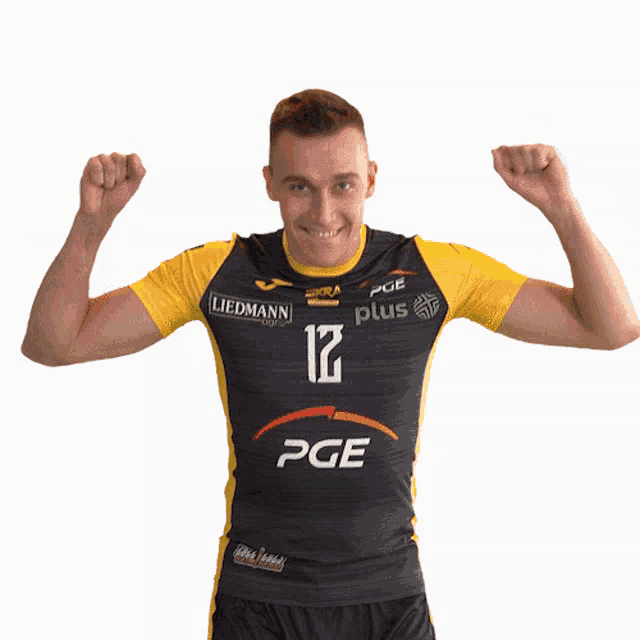 a man wearing a black and yellow pge jersey