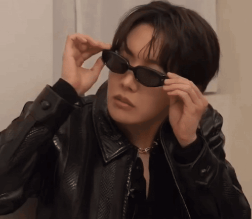 a man wearing sunglasses and a black jacket