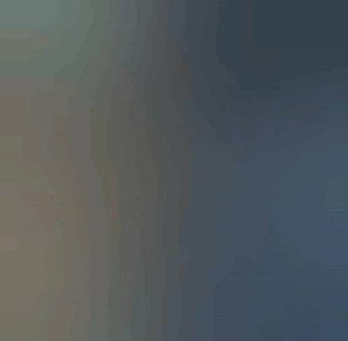 A soft gray-blue abstract transition frame with no readable scene or caption.