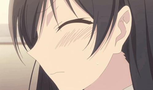 A blushing anime girl smiles bashfully with her eyes closed.