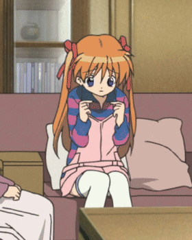 a girl with orange hair is sitting on a couch in a living room