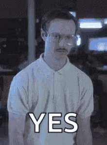A man in an office gives a restrained approving smile beside the word “YES.”