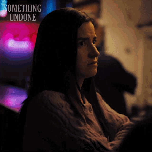 a poster for something undone shows a woman sitting in a dark room