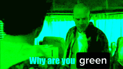 a man is talking to another man in a green room and the words `` why are you green '' are on the screen .