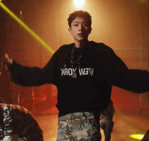 a young man is wearing a black sweater that says new york