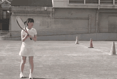 a woman in a white dress is holding a tennis racquet on a court