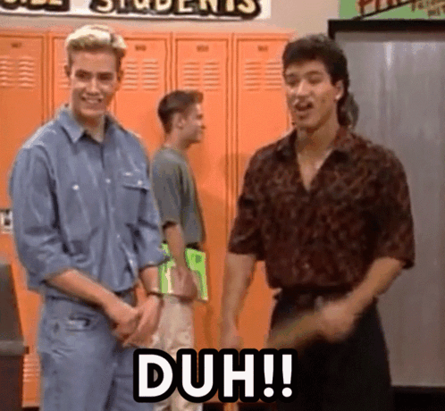 Two men stand in a school hallway beneath a large “DUH!!” caption.