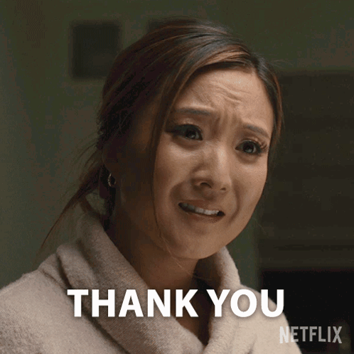 a woman in a bathrobe is making a thank you sign