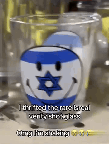 a shot glass with a smiley face and a jewish star on it