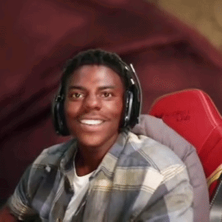 A headset-wearing streamer smiles broadly in amused surprise.