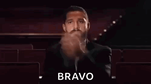 Shia LaBeouf claps in a dark theater with “BRAVO.”