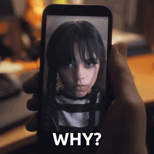 a person is holding a cell phone with a picture of a girl on it and the words why written below it