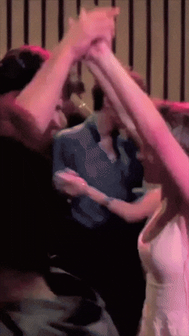 A couple dances closely in a dim scene from Dirty Dancing.