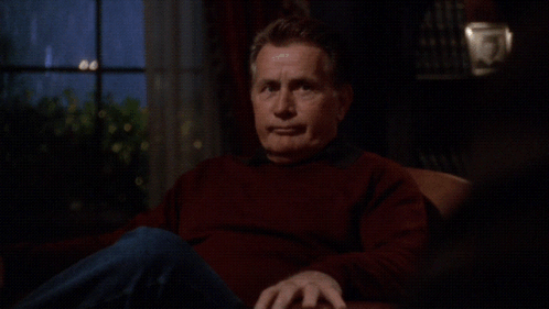 a man sitting in a chair with the words i get that a lot below him