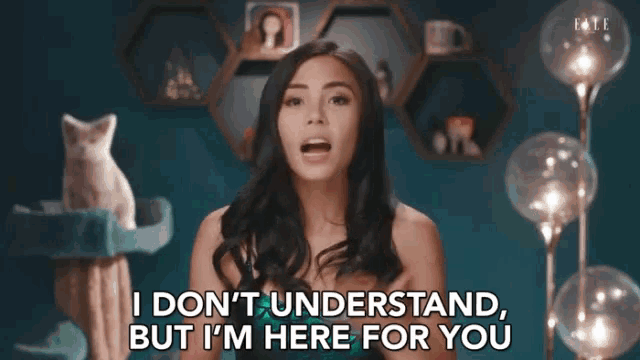 a woman says " i don 't understand but i 'm here for you " in front of a cat