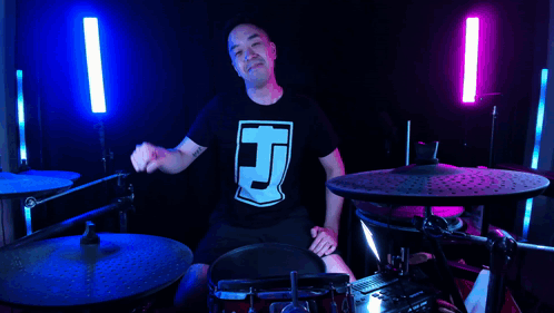 a man wearing a black shirt with the letter j on it