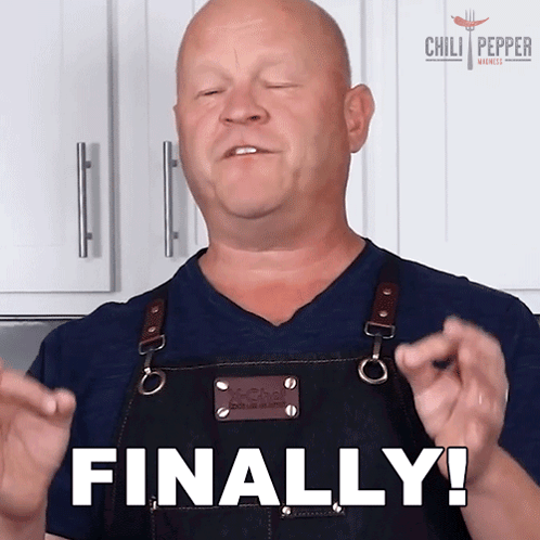 a man in an apron says finally with his hands in the air