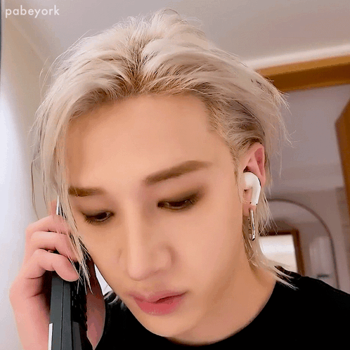 a close up of a person talking on a cell phone with the name pabeyork visible