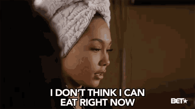 a woman with a towel wrapped around her head says i don 't think i can eat right now
