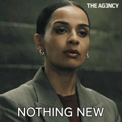 a woman in a suit says " nothing new " in front of her face