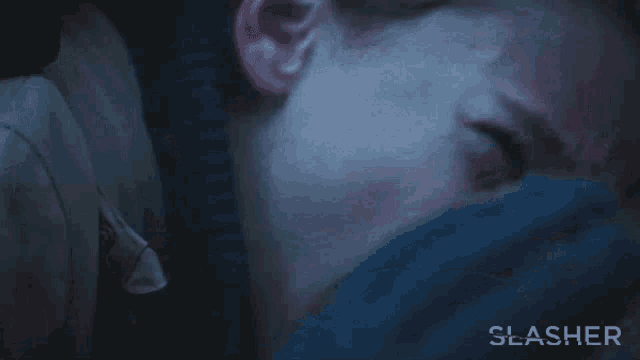 a close up of a man 's face with the word slasher written on the bottom