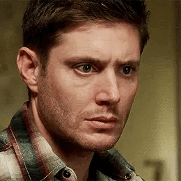 Dean Winchester looks forward with a confused, concerned stare.