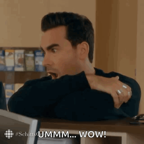 A sharply dressed man turns around with an astonished “UMMM… WOW!” reaction.