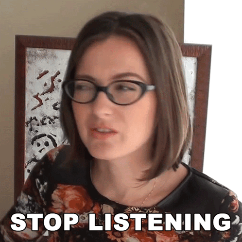 a woman wearing glasses says stop listening in front of a mirror