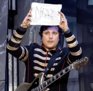 a man with a guitar is holding a sign that says " no "