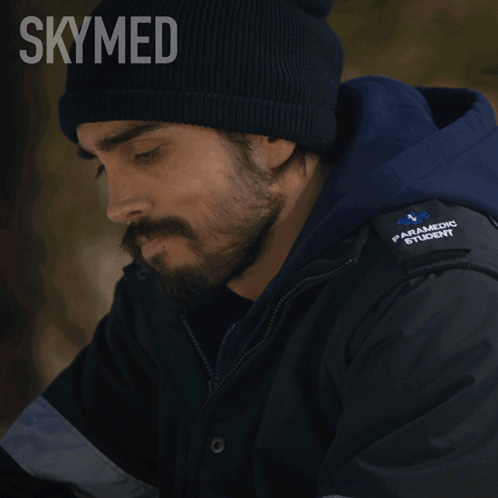 a man with a beard wearing a paramedic jacket says " i wanna help "