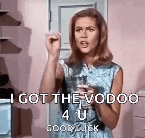 A woman raises a fist with subtitles reading “I GOT THE VOODOO 4 U GOOD LUCK.”